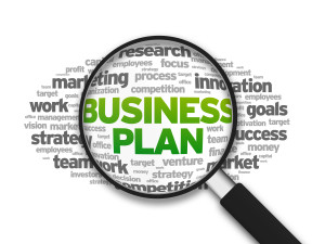 Magnified illustration with the word Business Plan on white background.